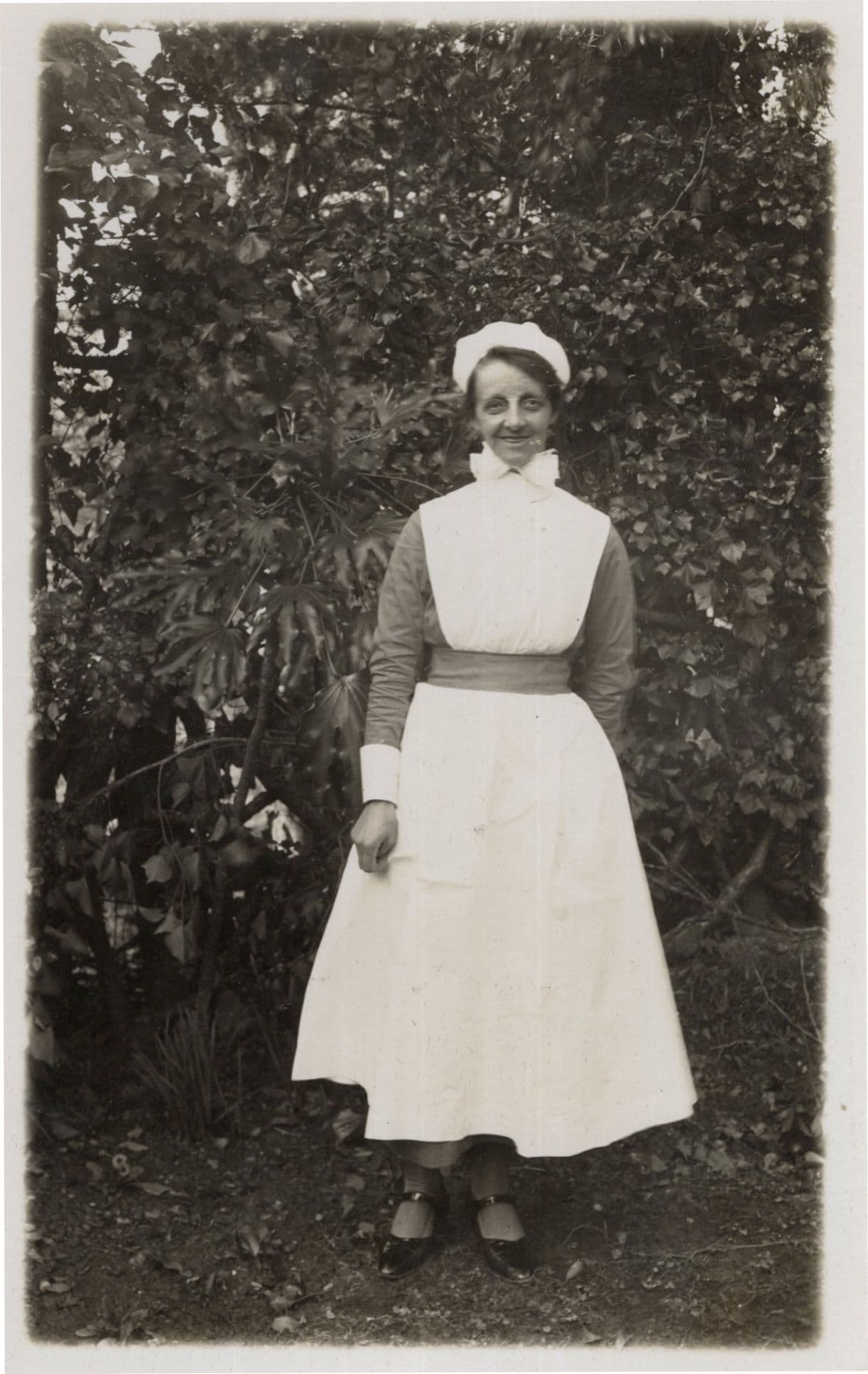 Grinning Nurse with Old Fashioned Bow Collar Real Photo Postcard